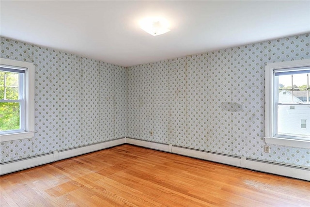 14 Manchester St, Bristol, RI 02809 - spare room with wallpapered walls, light wood-type flooring, and healthy amount of natural light