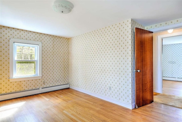 14 Manchester St, Bristol, RI 02809 - spare room featuring wallpapered walls, a baseboard heating unit, light wood-style flooring, and baseboards