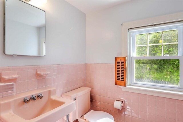 14 Manchester St, Bristol, RI 02809 - half bath featuring toilet, tile walls, and a sink