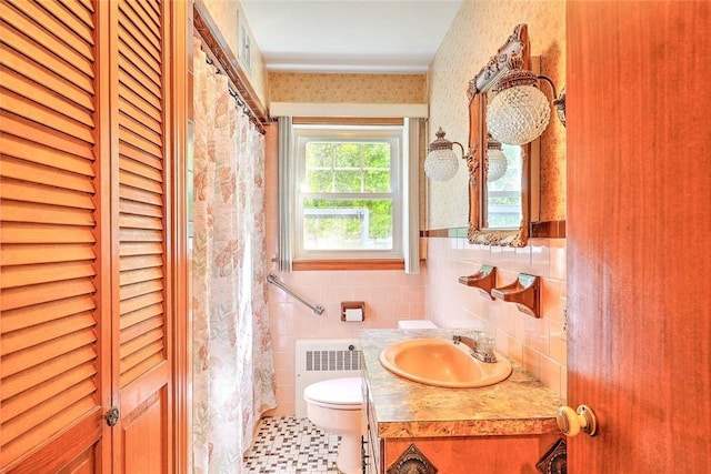 14 Manchester St, Bristol, RI 02809 - bathroom featuring radiator, tile walls, a closet, toilet, and vanity