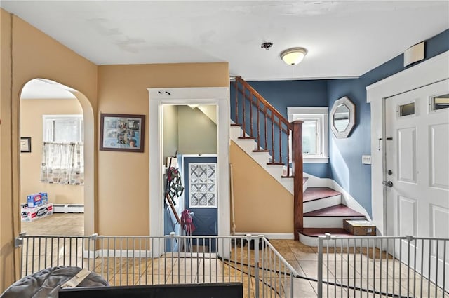 176 Warwick Ave, Cranston, RI 02905 - entrance foyer featuring a baseboard heating unit, arched walkways, and baseboards