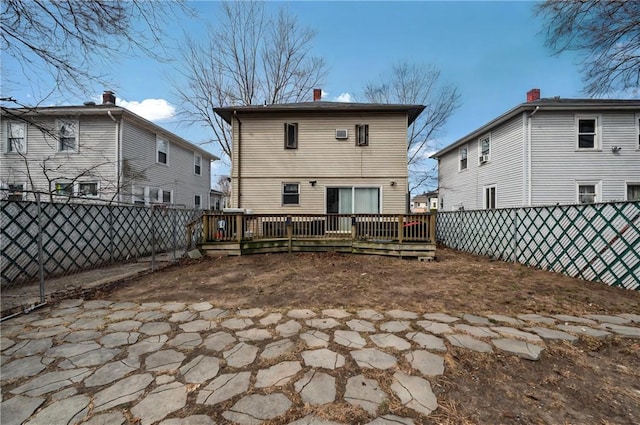 176 Warwick Ave, Cranston, RI 02905 - back of property featuring a fenced backyard, a deck, and a chimney