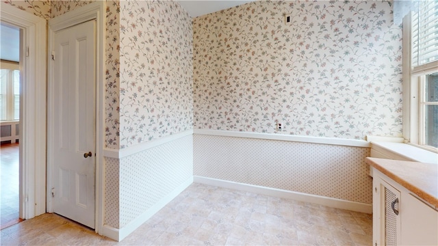 45 Ayrault Ave Unit 8, Newport, RI 02840 - unfurnished room with wallpapered walls, baseboards, radiator, and wainscoting