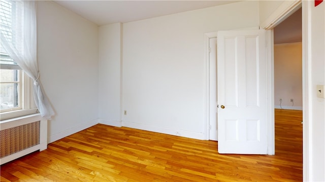 45 Ayrault Ave Unit 8, Newport, RI 02840 - unfurnished room with light wood-style flooring, radiator, and baseboards