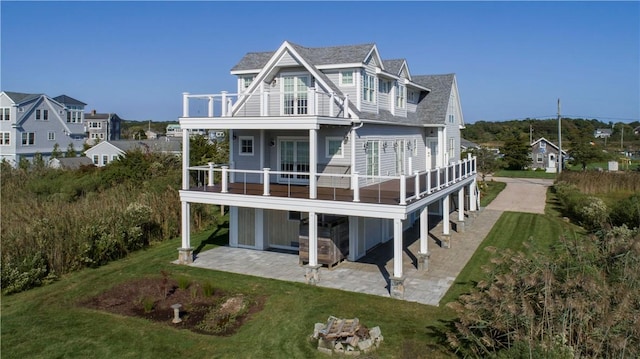 32 Breach Dr, Westerly, RI 02891 - back of property with a patio, a lawn, a balcony, and a shingled roof