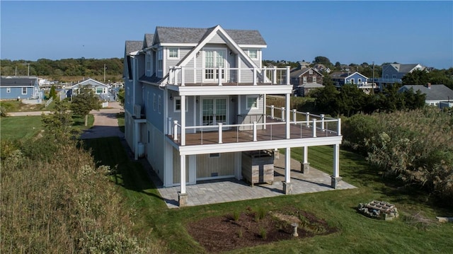 32 Breach Dr, Westerly, RI 02891 - back of property with a balcony, a patio, and a lawn