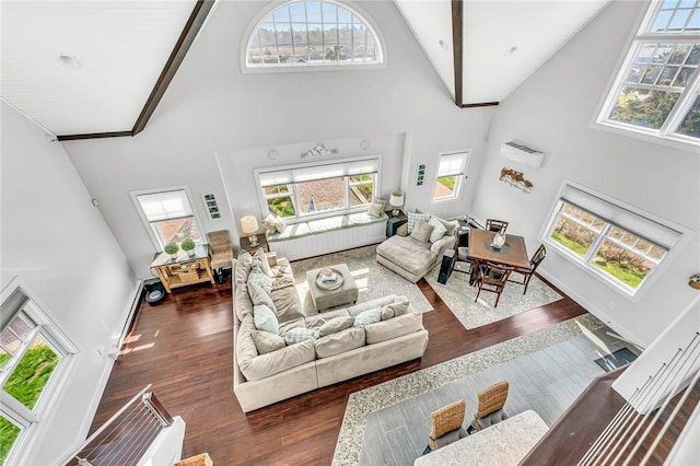 32 Breach Dr, Westerly, RI 02891 - living area with high vaulted ceiling, plenty of natural light, wood finished floors, and baseboards