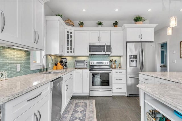 32 Breach Dr, Westerly, RI 02891 - kitchen featuring appliances with stainless steel finishes, a sink, white cabinets, tasteful backsplash, and recessed lighting