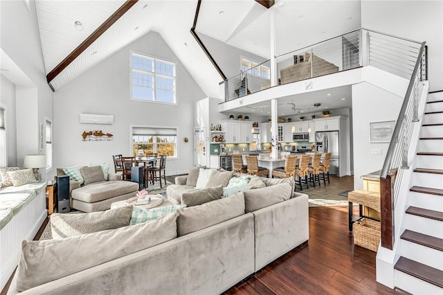 32 Breach Dr, Westerly, RI 02891 - living area with stairway, high vaulted ceiling, dark wood finished floors, and a wall unit AC