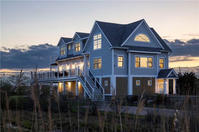 32 Breach Dr, Westerly, RI 02891 - view of front facade with stairway, roof with shingles, and a wooden deck