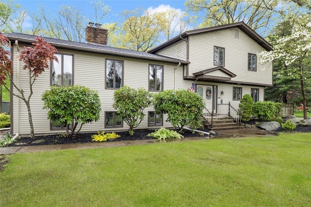 218 Burnt Cedar Dr, North Kingstown, RI 02852 - split level home with a chimney and a front yard