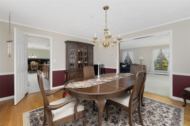 218 Burnt Cedar Dr, North Kingstown, RI 02852 - dining space with a chandelier, light wood-style floors, crown molding, and baseboards