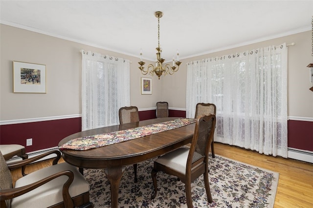 218 Burnt Cedar Dr, North Kingstown, RI 02852 - dining space with a chandelier, wood finished floors, and crown molding