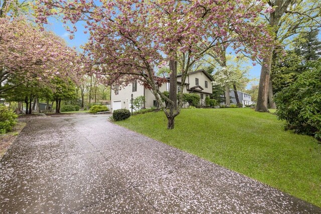 218 Burnt Cedar Dr, North Kingstown, RI 02852 - view of front of home featuring driveway, a garage, and a front lawn
