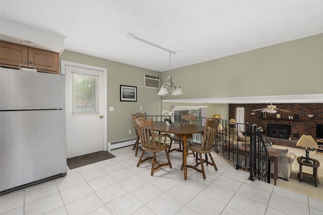 218 Burnt Cedar Dr, North Kingstown, RI 02852 - dining room with baseboard heating, a fireplace, a wall unit AC, a ceiling fan, and light tile patterned flooring