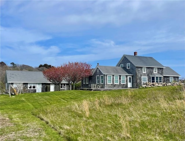 899 Cooneymus Rd, Block Island, RI 02807 - back of property with a lawn and a chimney