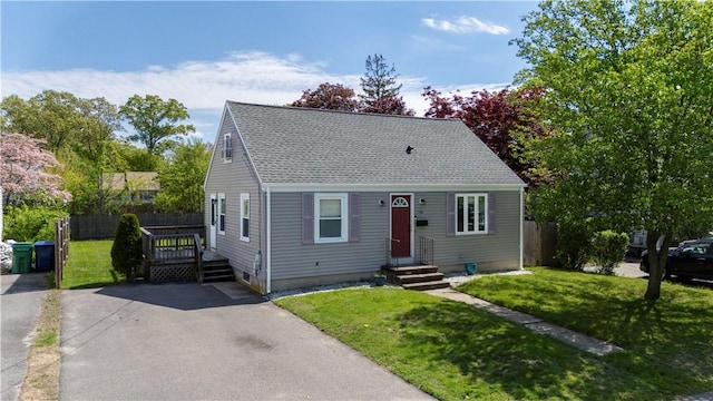 cape cod home featuring roof with shingles
