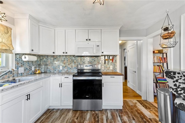 kitchen featuring white microwave, electric stove, a sink, dark wood-style floors, and white cabinets