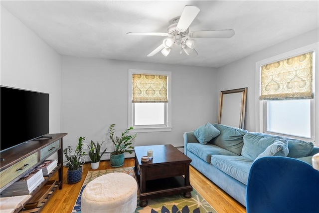 living room featuring wood finished floors and ceiling fan