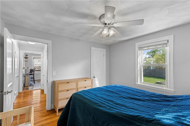 bedroom with light wood finished floors and a ceiling fan