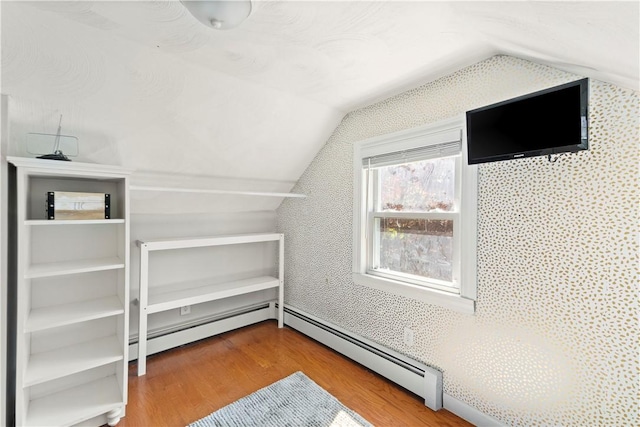 bonus room with vaulted ceiling, wood finished floors, and a baseboard radiator