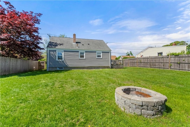rear view of house featuring an outdoor fire pit and a chimney