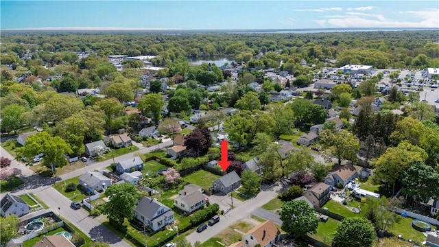 view of property location with a heavily wooded area and nearby suburban area
