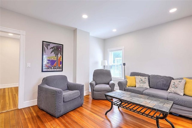living room with hardwood / wood-style flooring, baseboards, and recessed lighting