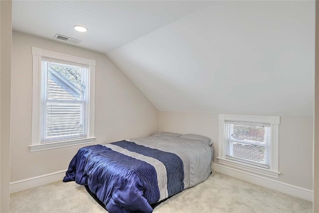 bedroom with carpet flooring, lofted ceiling, and baseboards