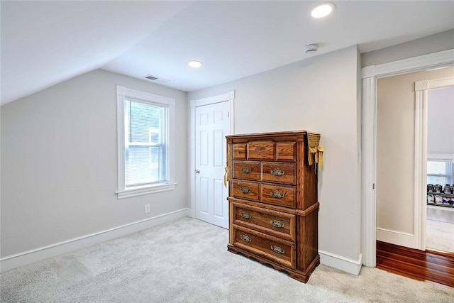 additional living space featuring vaulted ceiling, carpet flooring, plenty of natural light, baseboards, and recessed lighting