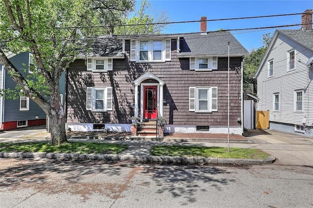 view of front of home featuring a chimney and entry steps
