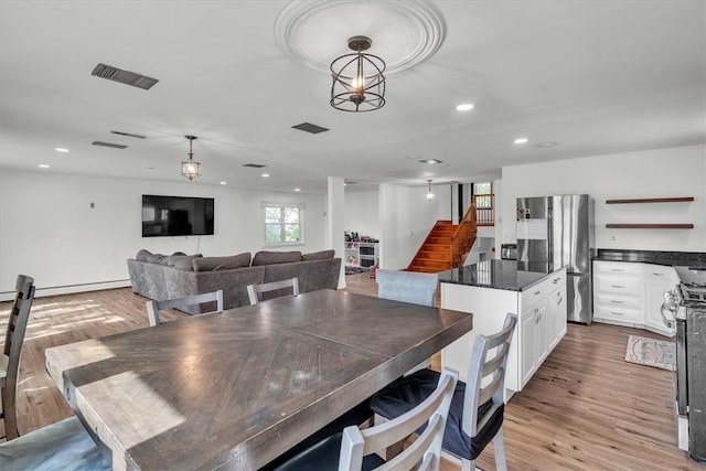 dining room with stairway, recessed lighting, light wood-style flooring, and baseboard heating