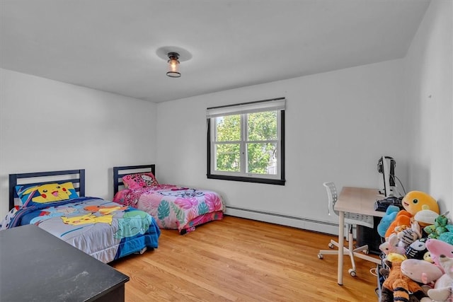 bedroom featuring a baseboard radiator and wood finished floors