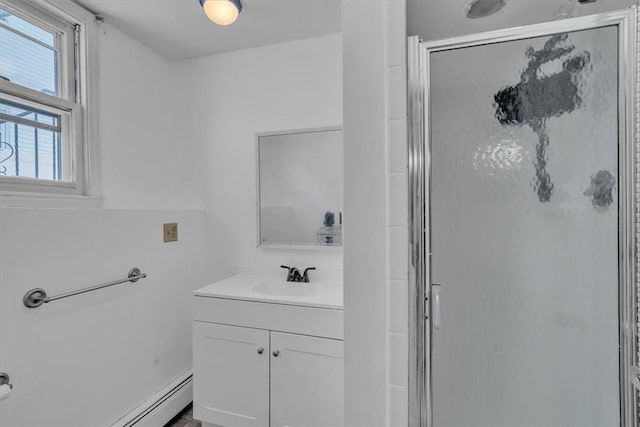 bathroom with a shower stall and vanity