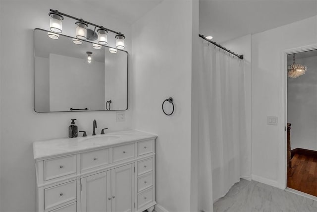 bathroom with baseboards, vanity, marble finish floors, and a shower with shower curtain