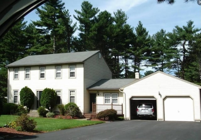15 Wood Cove Dr, Coventry, RI 02816 - colonial home featuring a garage, driveway, and a chimney