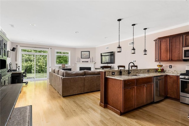 16 Kimberly Ct, North Kingstown, RI 02852 - kitchen with a sink, stainless steel appliances, open floor plan, a peninsula, and ornamental molding