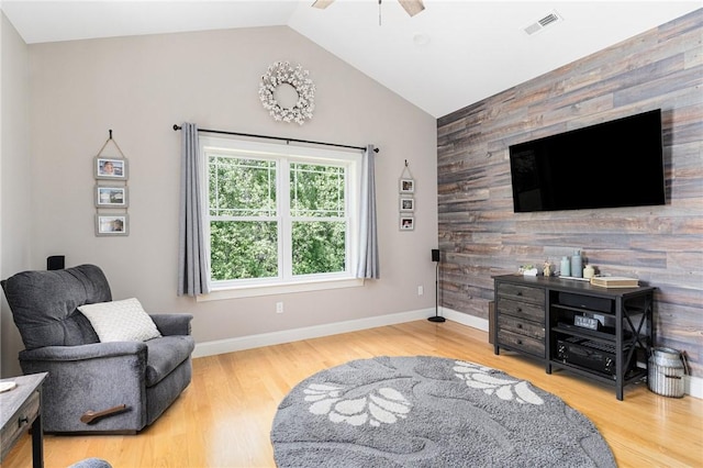 16 Kimberly Ct, North Kingstown, RI 02852 - sitting room featuring ceiling fan, vaulted ceiling, wood finished floors, an accent wall, and wooden walls