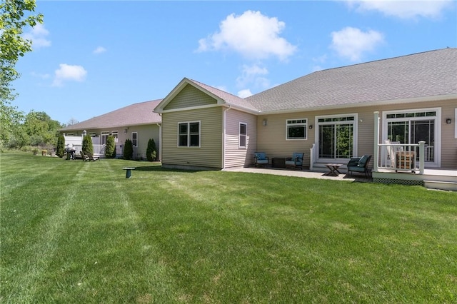 16 Kimberly Ct, North Kingstown, RI 02852 - rear view of property featuring a lawn, a patio area, and a deck