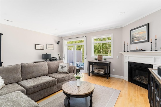 16 Kimberly Ct, North Kingstown, RI 02852 - living area featuring light wood-style floors, ornamental molding, a glass covered fireplace, an office area, and baseboards