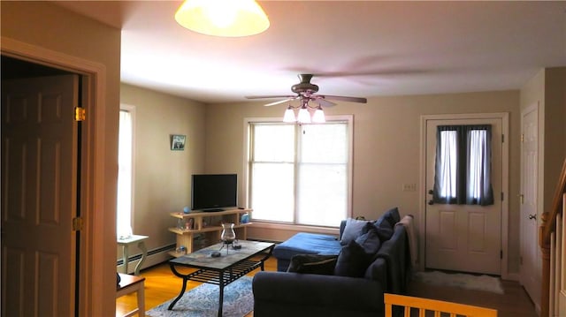 94 Barton St, Pawtucket, RI 02860 - living area with ceiling fan, light wood-style flooring, and a baseboard radiator