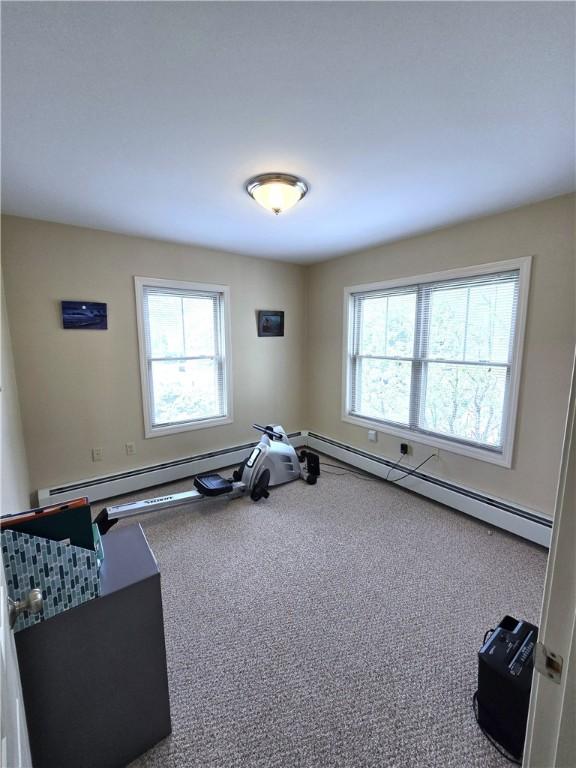 94 Barton St, Pawtucket, RI 02860 - workout room featuring plenty of natural light, baseboard heating, and carpet floors