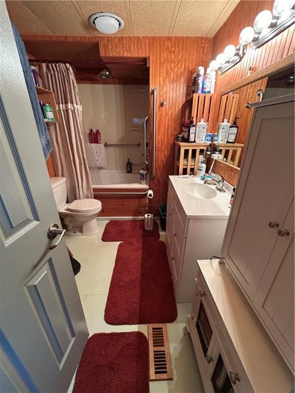 245 Manton St, Pawtucket, RI 02861 - full bathroom featuring toilet, vanity, shower / bath combo, and wood walls