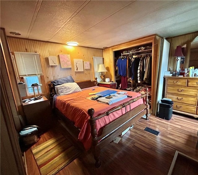 245 Manton St, Pawtucket, RI 02861 - bedroom featuring a closet, wood finished floors, and wood walls
