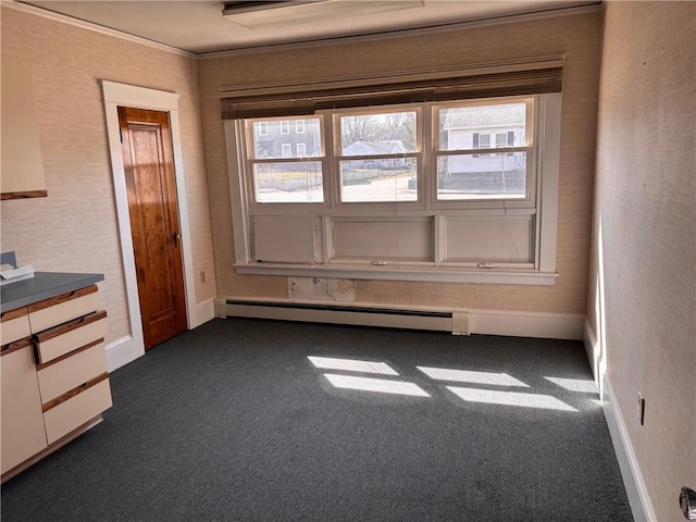 unfurnished room with baseboard heating, plenty of natural light, baseboards, dark carpet, and ornamental molding