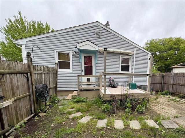 74 Lubec St, Providence, RI 02904 - back of house with a wooden deck, a fenced backyard, and cooling unit