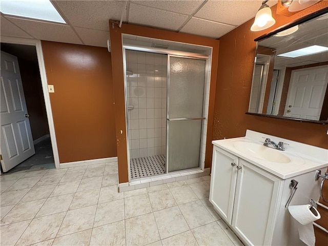 74 Lubec St, Providence, RI 02904 - bathroom featuring a shower stall, vanity, a drop ceiling, tile patterned floors, and baseboards