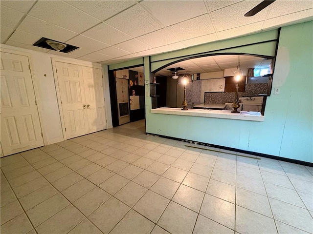 74 Lubec St, Providence, RI 02904 - unfurnished living room with a paneled ceiling, tile patterned floors, and a ceiling fan