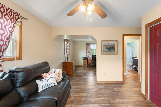 30 Saundra Dr, Westerly, RI 02891 - living room featuring arched walkways, wood finished floors, ceiling fan, and baseboards
