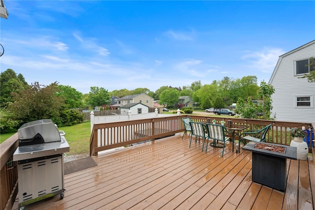 30 Saundra Dr, Westerly, RI 02891 - wooden terrace with an outdoor fire pit, outdoor dining space, view of scattered trees, and a residential view